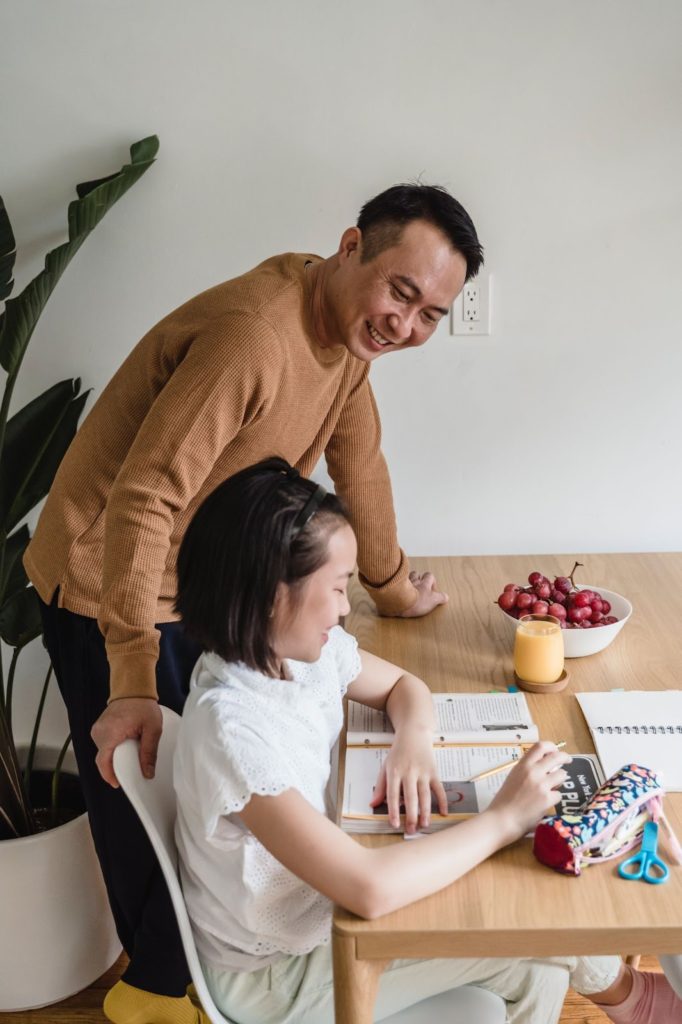 two people studying together with food and drink on the table